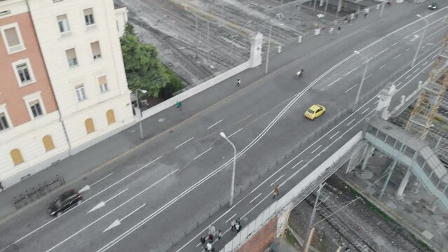 Aerial Shot Following A Yellow Car On An Italian Street