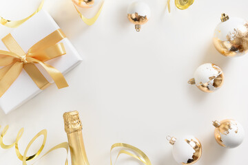Xmas composition with shiny gold balls, champagne bottle on white background. Greeting card with...