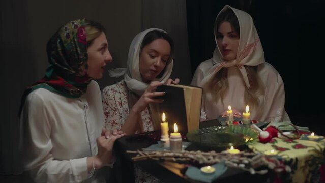 4K. Slavic women fortune-telling in a dark room by candlelight