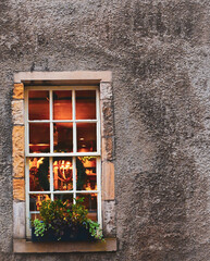 view of a window on a gray facade with a Christmas theme and a warm atmosphere