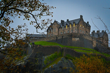 view of edimburg castle on its hill from the park below
