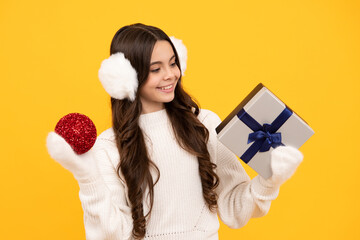 Teenager child with gift box. Present for winter holidays. Happy New Year or Christmas. Kid in sweater hold present box with gift ribbon bow.