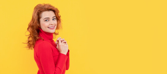 Woman isolated face portrait, banner with copy space. happy redhead woman with curly hair smiling on yellow background, beauty.