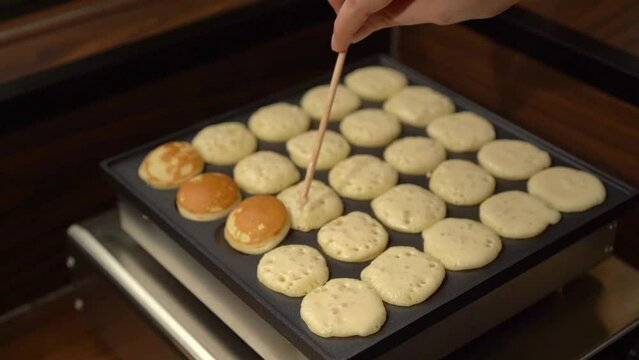 Mini Pancake hotcakes preparation dough flip over