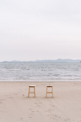 Two chairs lying on the beach with a comfortable and peaceful feeling