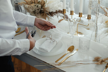 High angle view of an anonymous woman making decoration with dry flower for plate while hosting new year party