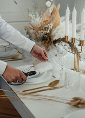 Close Up Photo Of Woman Hands Setting Up Christmas Dinner Table At Home