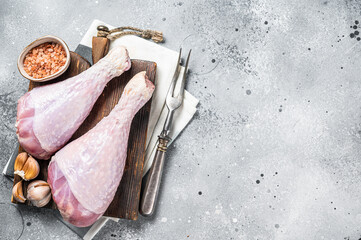 Raw turkey legs, Poultry meat. Gray background. Top view. Copy space