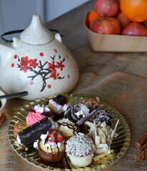 Christmas cookies on a plate and coffe cup on a decorated table. Dessert of cookies plate perfect for celebrating Christmas.