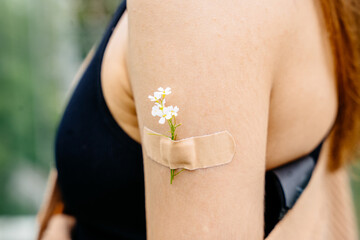 Close up of shoulder vaccinated woman. Millennial latin woman showing glued patch.