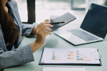 Business team present. professional investor working new start up project. Finance managers meeting.Digital tablet docking screen computer design smart phone using, in morning light