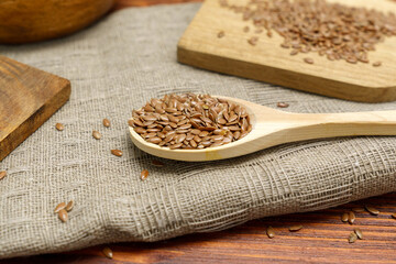 Brown flax seed background. Flaxseed oil preparation. Flax oil is rich in omega-3 fatty acid.