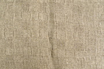 Structure of beige linen fabric. Linen Material, Textile Industry. Selective focus