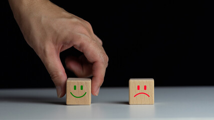 best excellent business services rating customer experience. Satisfaction survey concept. Hand of a businessman chooses a smiley face on wood block cube. 5 Star Satisfaction