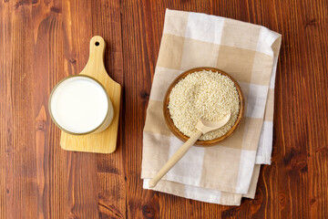 Milk with sesame on wooden background, Healthy drink. Raw food diet. Vegan concept.