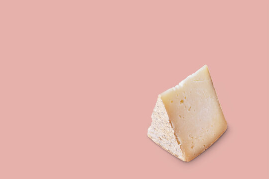 Piece of pecorino cheese. Top italian cheeses - Pecorino Cheese. Piece of italian pecorino cheese on pink background