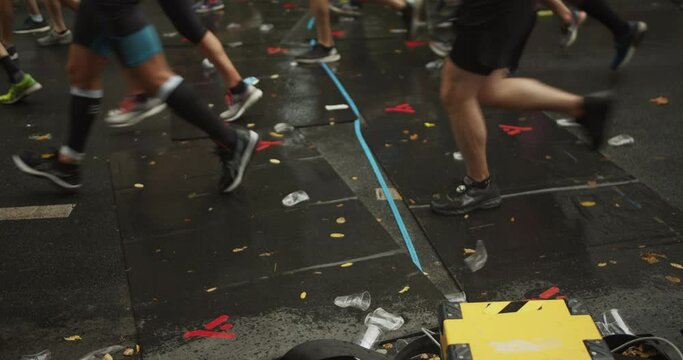 Athletes running over timing equipment on street. Cropper view of legs. Marathon run race, Berlin, Germany