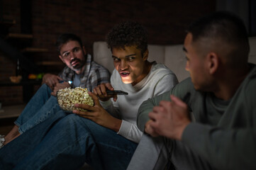 Three pals sitting in the dark on the floor mat