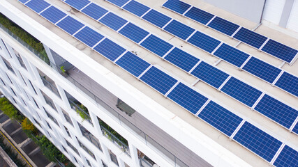 Aerial view on solar panels installed on the roof of a building. Solar energy accumulators. Green...