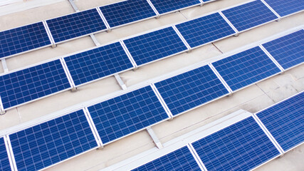 Aerial view on solar panels installed on the roof of a building. Solar energy accumulators. Green...