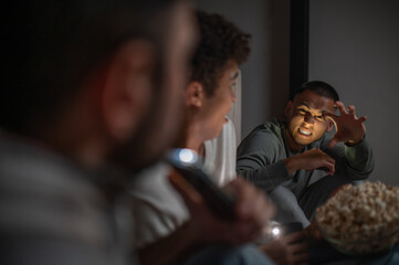 Company of buddies sitting in the dark