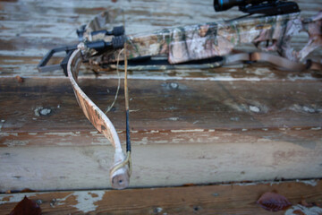 A frayed, worn out, broken bowstring that will need to be replaced.  This is general maintenance on compound and crossbows, and is very important to keep in good repair. Shallow depth of field.