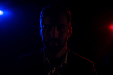 Photo of standing man and pink light on the background.