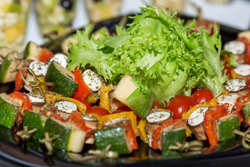 Vegetable appetizer with fresh lettuce leaves on the table. Diet healthy nutrition and health care. Close-up.