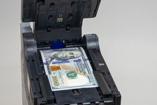Close-up of maintenance and repair mechanism of the bill acceptor of an ATM with a stuck bill