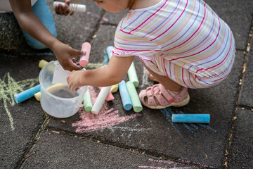 Two interracial kids engaged in a creative activity