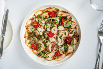 octopus carpaccio with tomato and herb