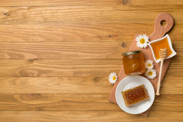 Composition with fresh honey on wooden background, top view