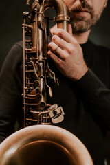 man playing saxophone on stage