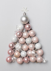Christmas tree made of bauble decoration on color background, top view