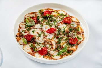 octopus carpaccio with tomato and herb