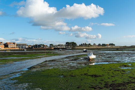 A fishing boat at low tide on the Hamshire coast in England.