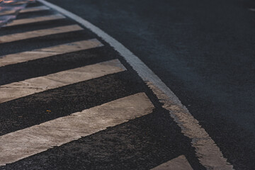 Obraz premium White dirty pedestrian crosswalk painted on black asphalt or road mark for refuge