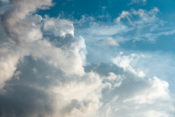 Naklejka na ściany i meble Clouds formation against blue sky. Rainy climate with fantastic cloudscape