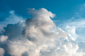 Naklejka na ściany i meble View above the clouds during daytime. Cloudscape natural scene with cumulus on a sunny day