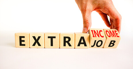 Extra job and income symbol. Concept words Extra job Extra income on wooden cubes. Businessman...
