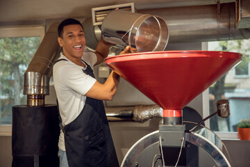Joyful roast master posing for the camera at work