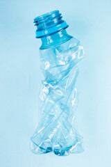 Close up of plastic stripped bottle on blue background