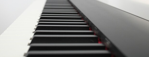 High-angle grayscale view of modern piano keys