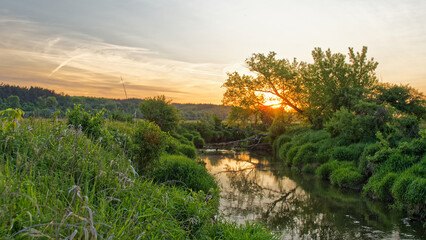 Fototapeta na wymiar Sunset over the river. Summer landscape.