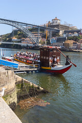 Fototapeta na wymiar a small cruise liner with tourists is preparing to sail from the city pier. Travel concept. Porto. Portugal