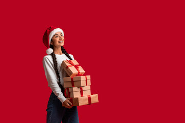 Beautiful Arab Woman In Santa Hat Holding Stack Of Gift Boxes