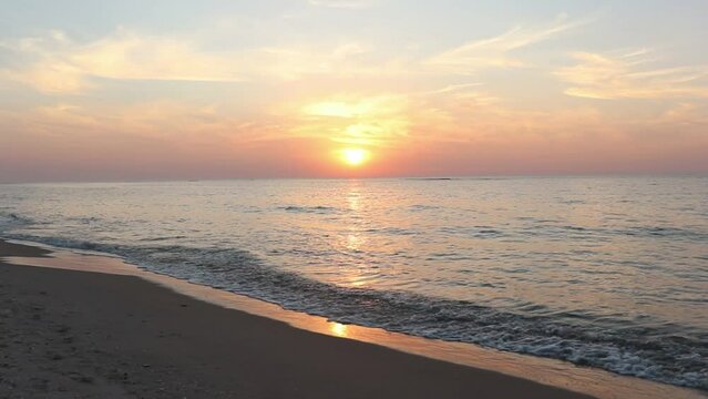 Beautiful beach in Palmahim, Israel at sunset over the water with wave crashing sound in the background