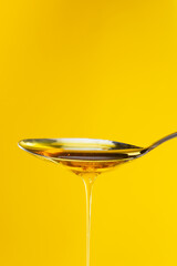 honey drizzling onto a spoon 