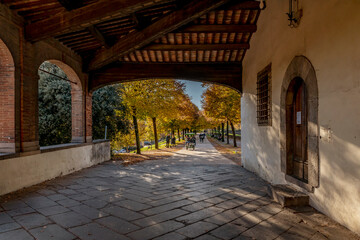 The street of the ancient city walls of Lucca, Italy, at the Santa Maria gate, with the colors of autumn