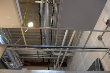 Obraz premium 90 degree bend in conduit above ceiling grid